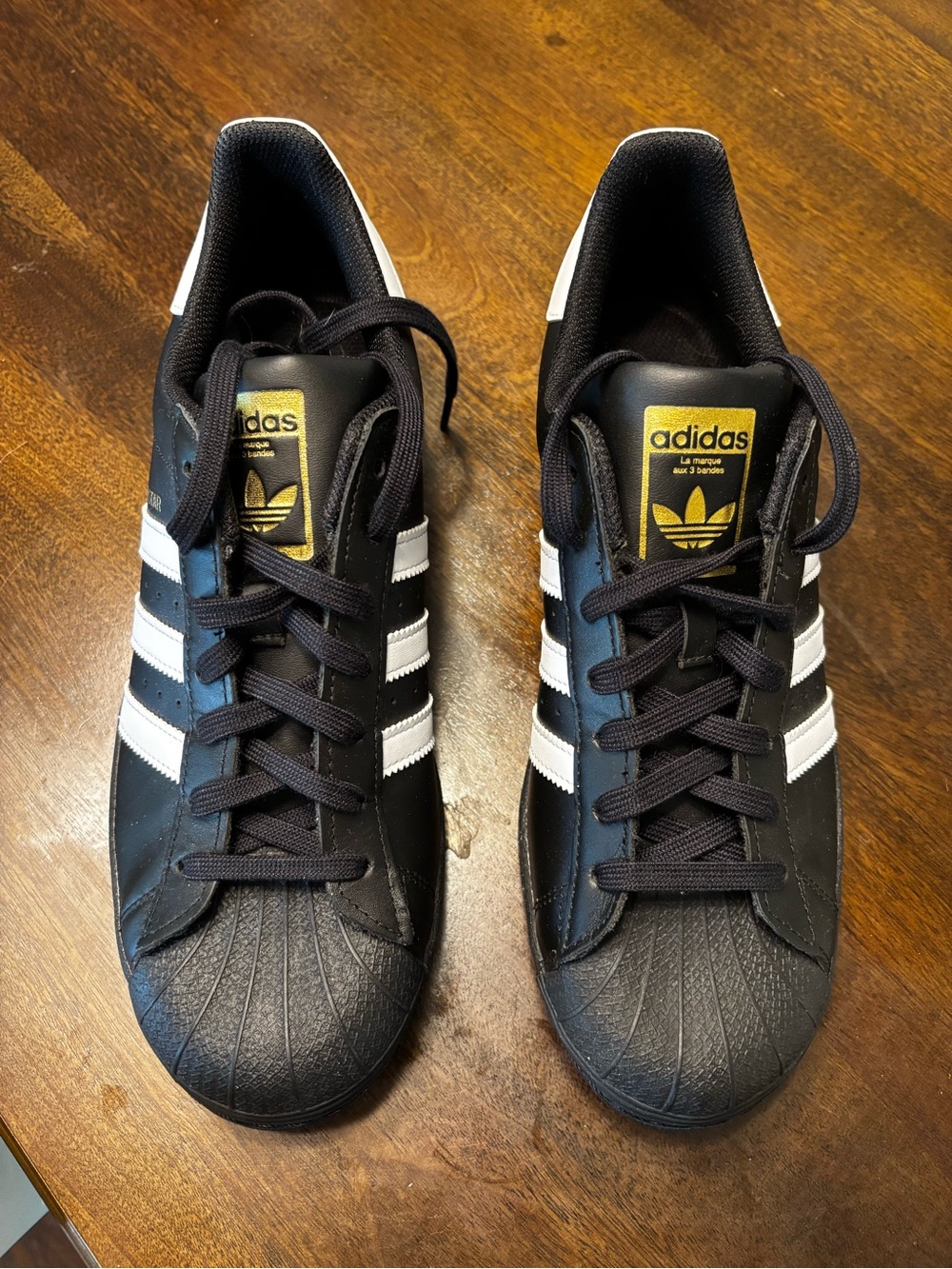 adidas Black Sneakers with White Stripes and Gold Tongue Badge
